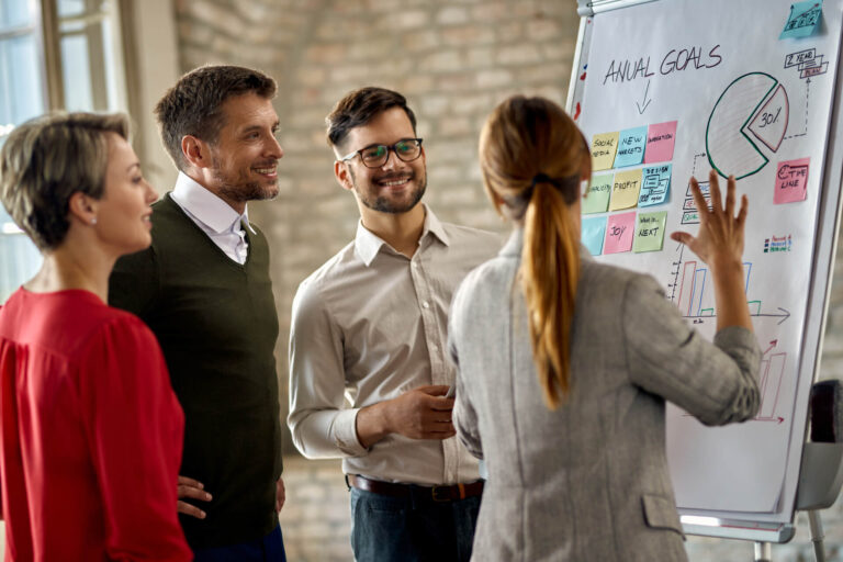 happy-business-team-cooperating-while-analyzing-their-business-progress-whiteboard-office (1)